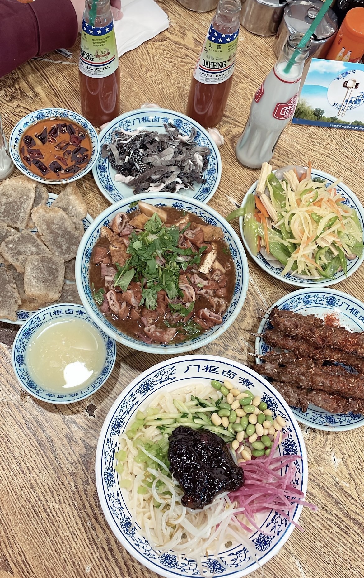 Luzhu bowl at the center of a larger Beijing restaurant meal