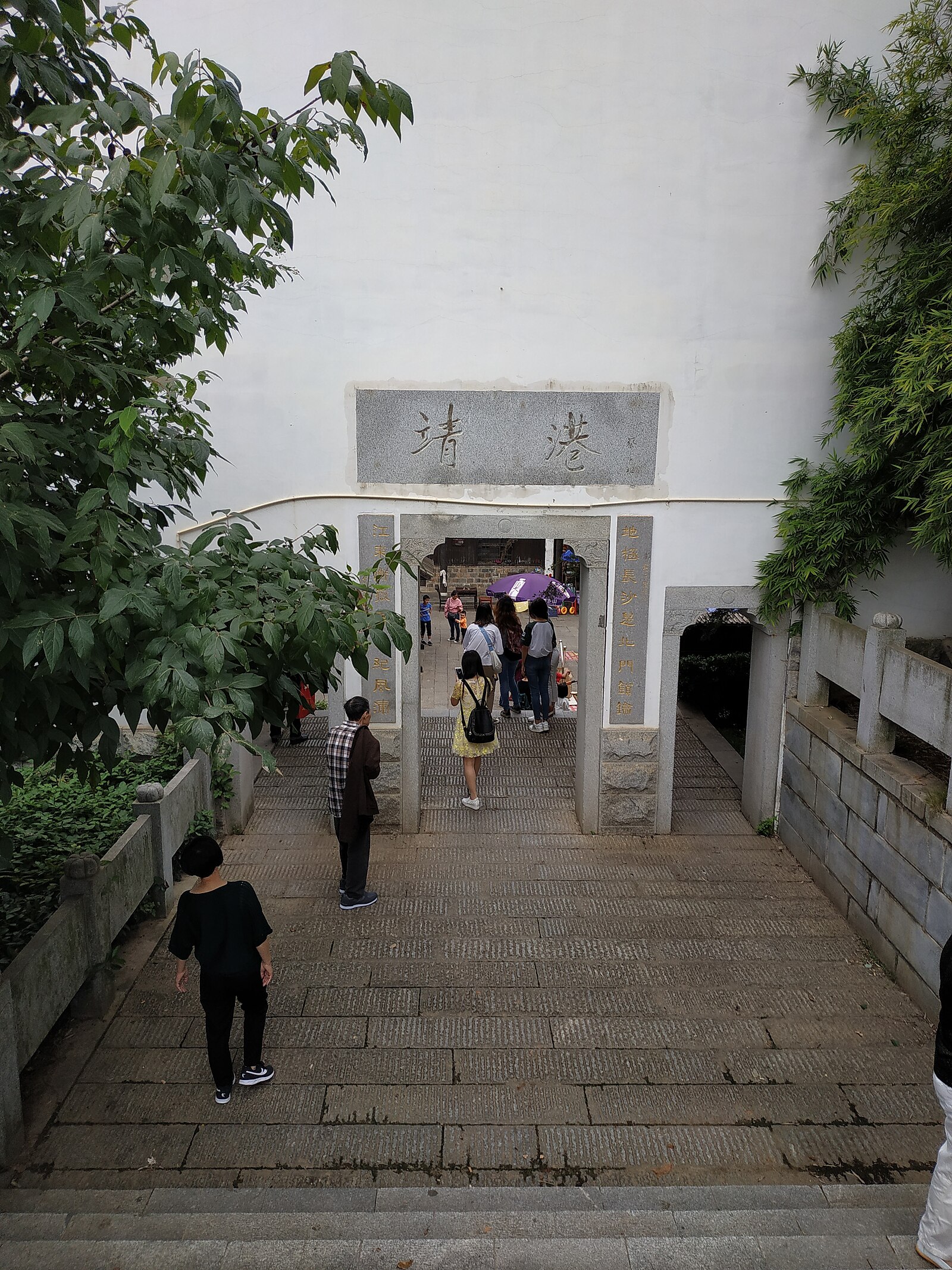 Visitors passing through a gate at Jinggang historic town