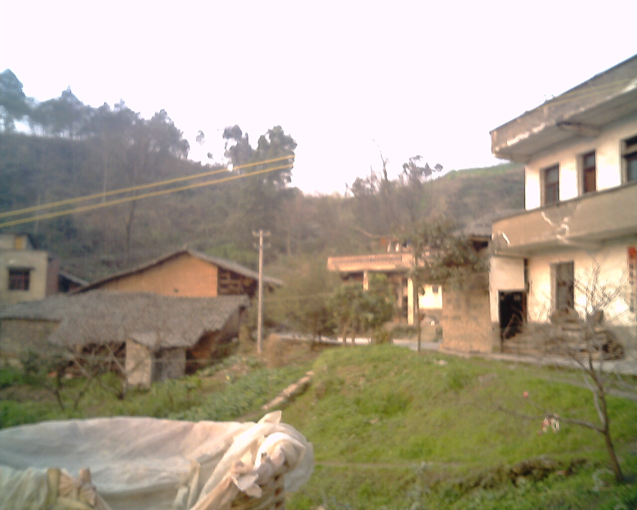 Dated village courtyard and cultivated slope in Huaying