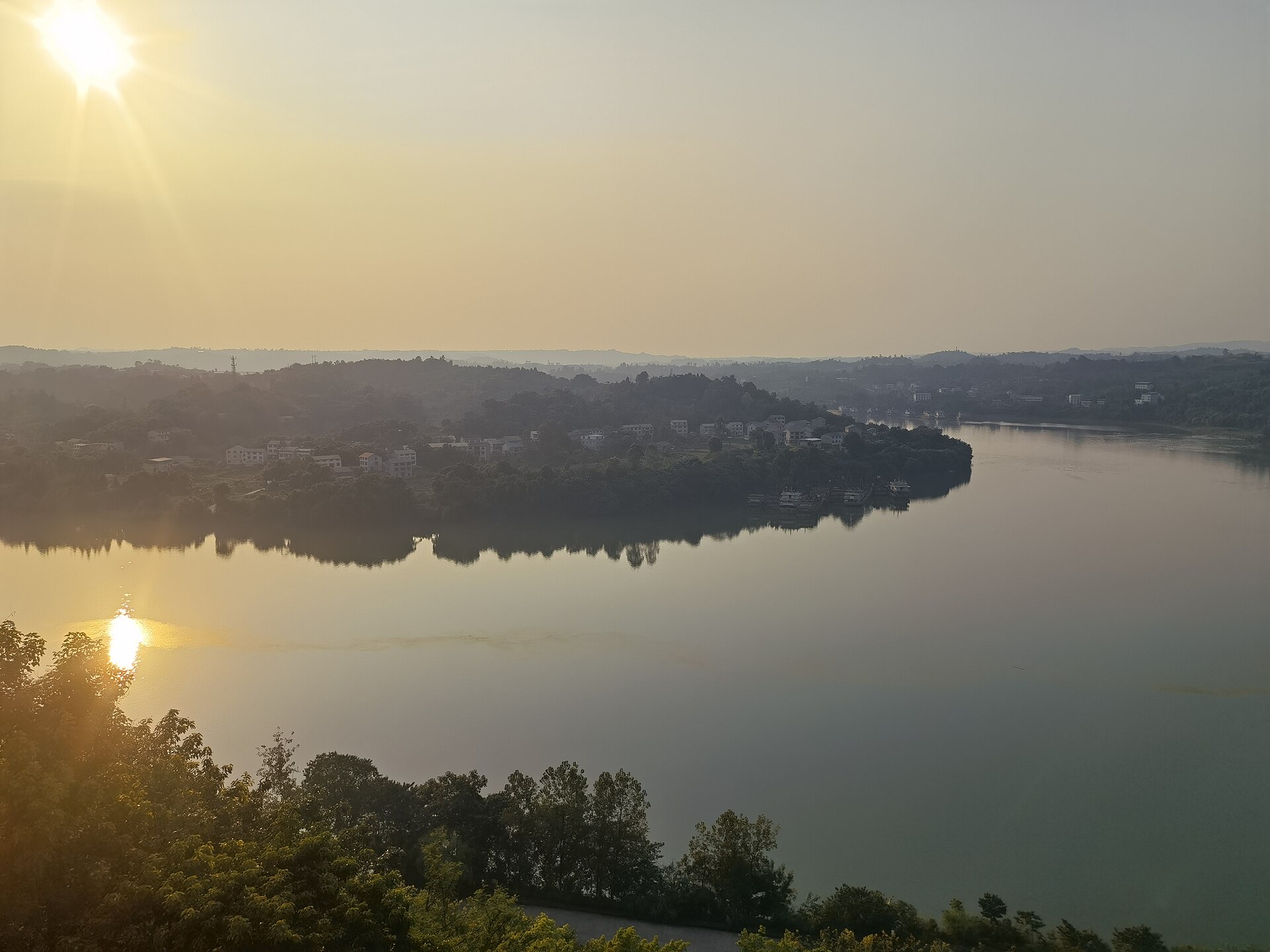 Sunset over a Jialing River bend and settlement in Wusheng