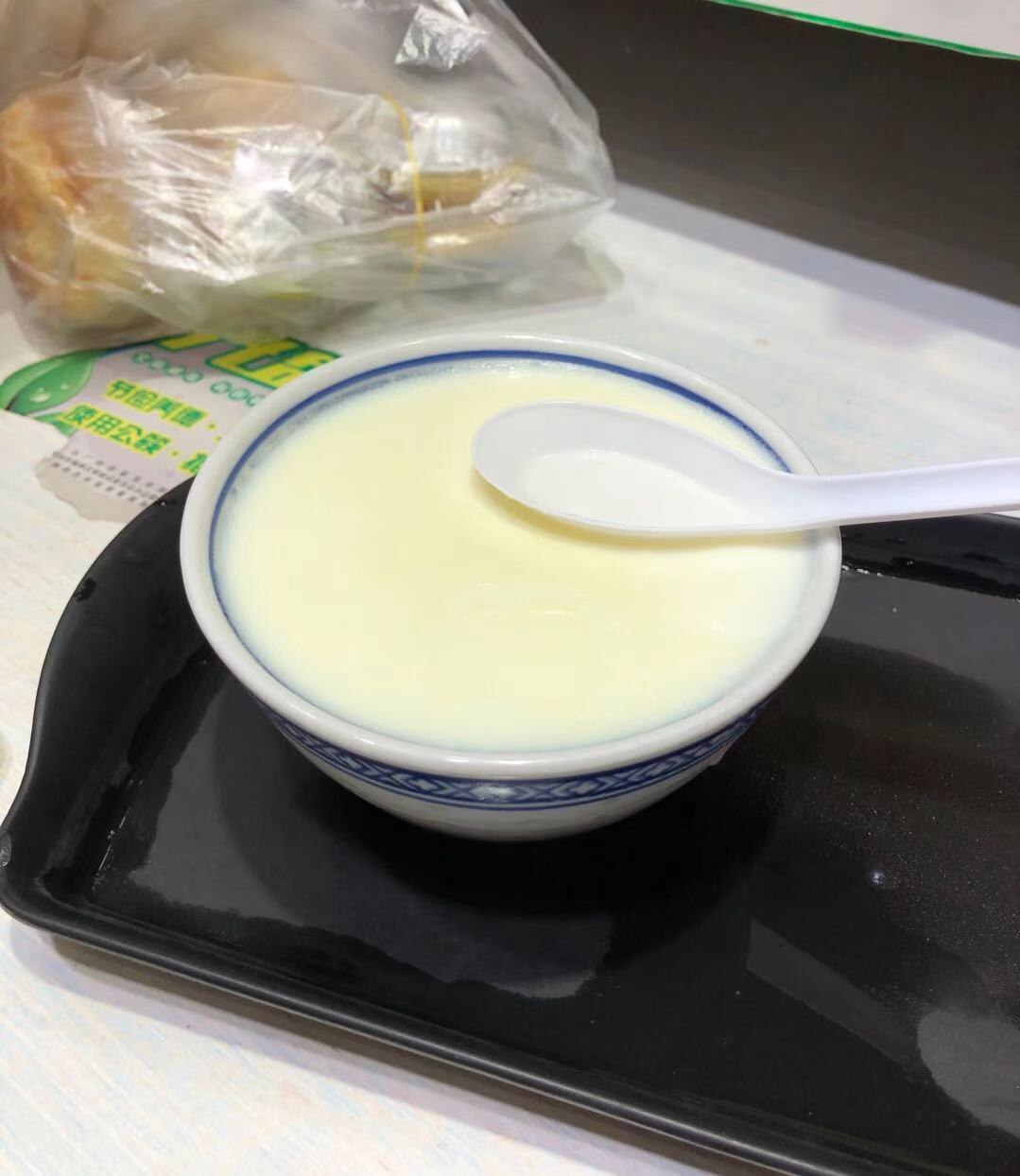 Pale milk custard in a blue-rimmed bowl