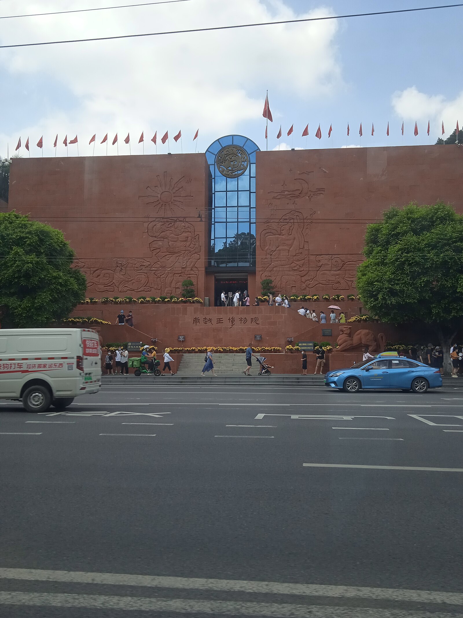 Red museum facade above a busy Guangzhou street