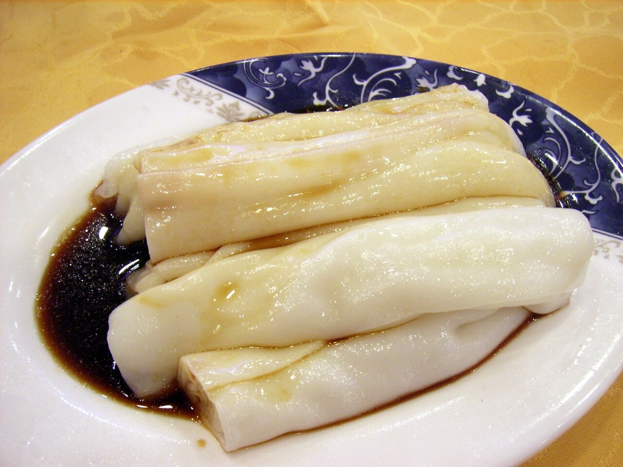 Soft rice noodle rolls with dark soy-based sauce