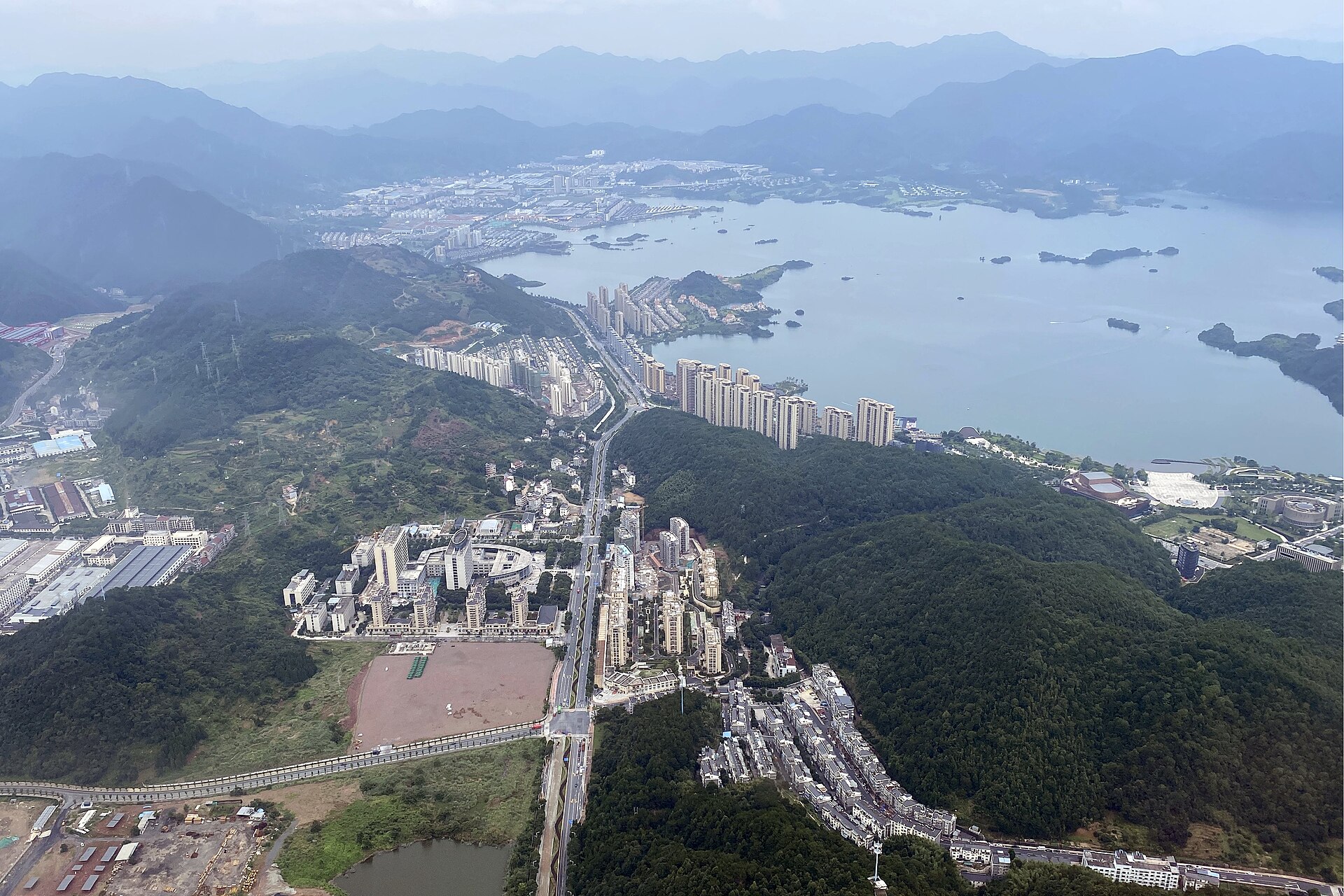 Aerial view of Chun'an county seat, forested hills and Qiandao Lake islands
