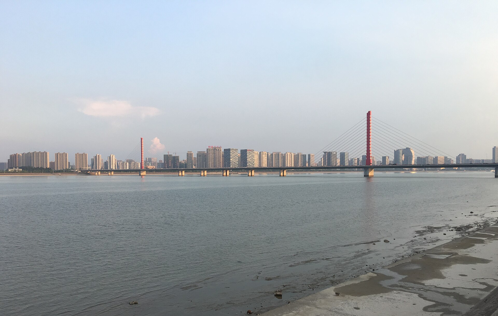Broad Qiantang River, bridge and urban skyline in daylight