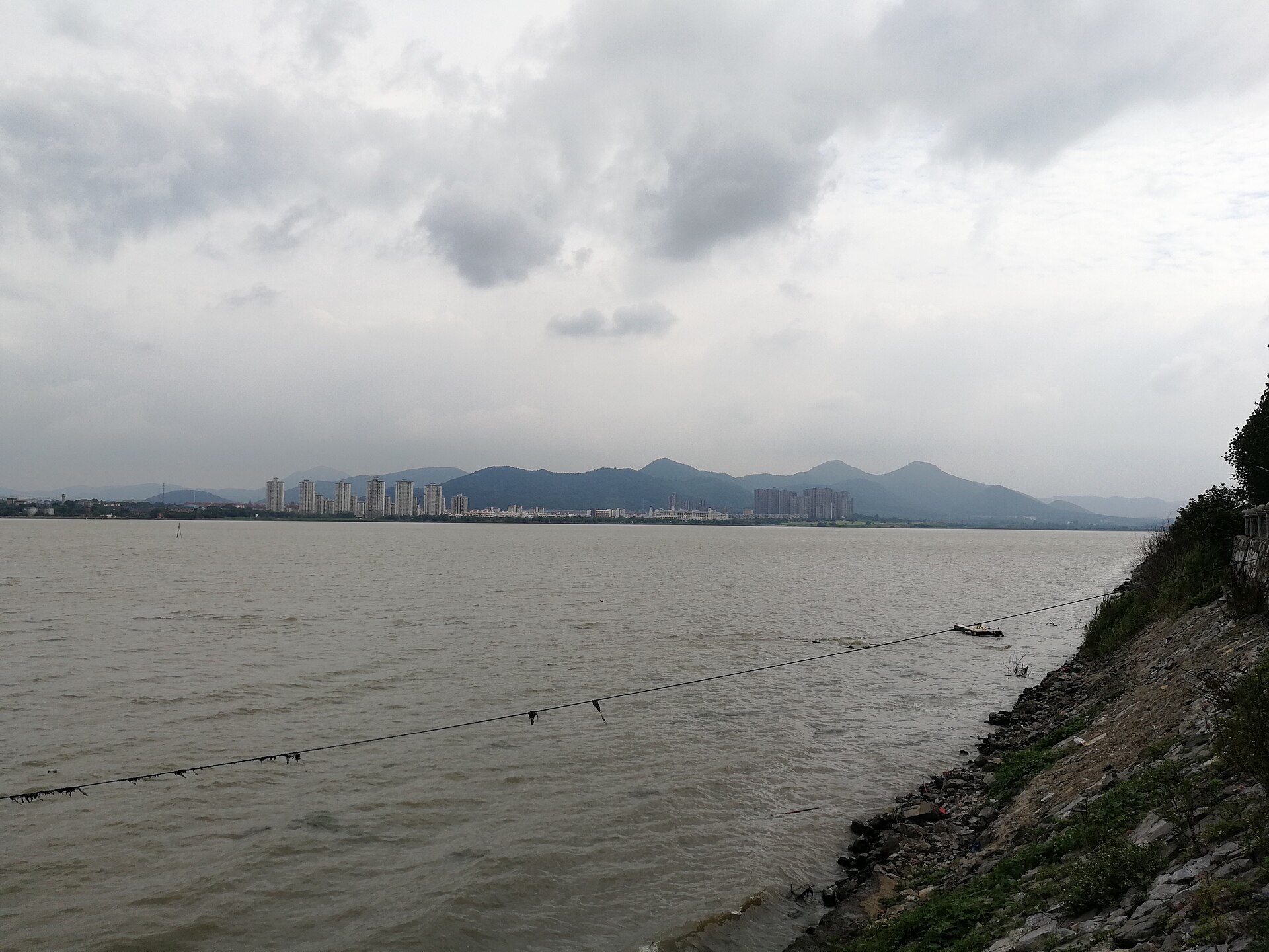Wide 2017 landscape of Chaohu Lake, hills and a shore settlement