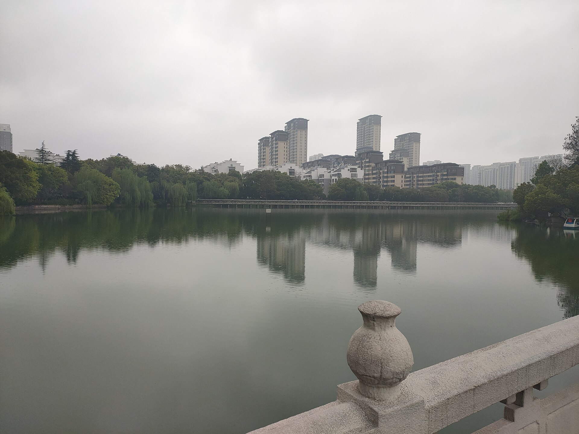 Overcast 2024 view across Yaohai Park lake toward housing