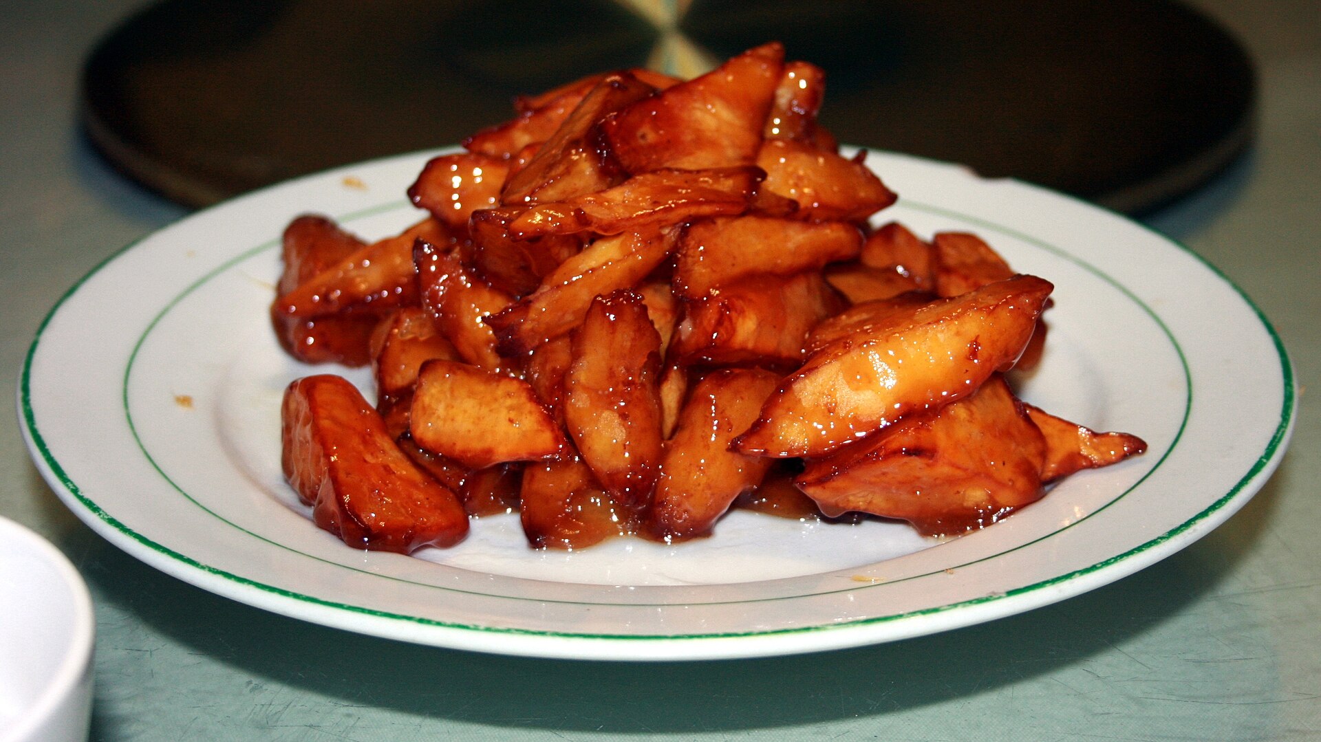 Glossy candied sweet-potato pieces served in Jinan