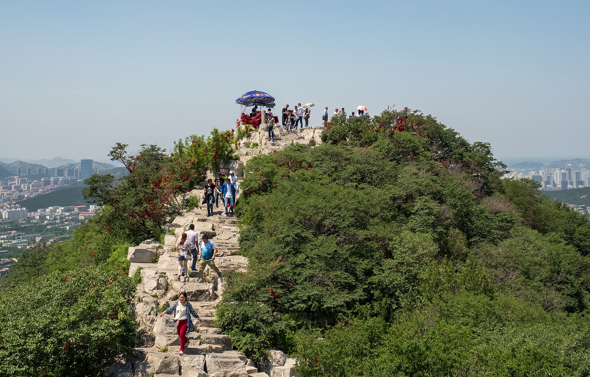Visitors walking a ridge path on Thousand Buddha Mountain