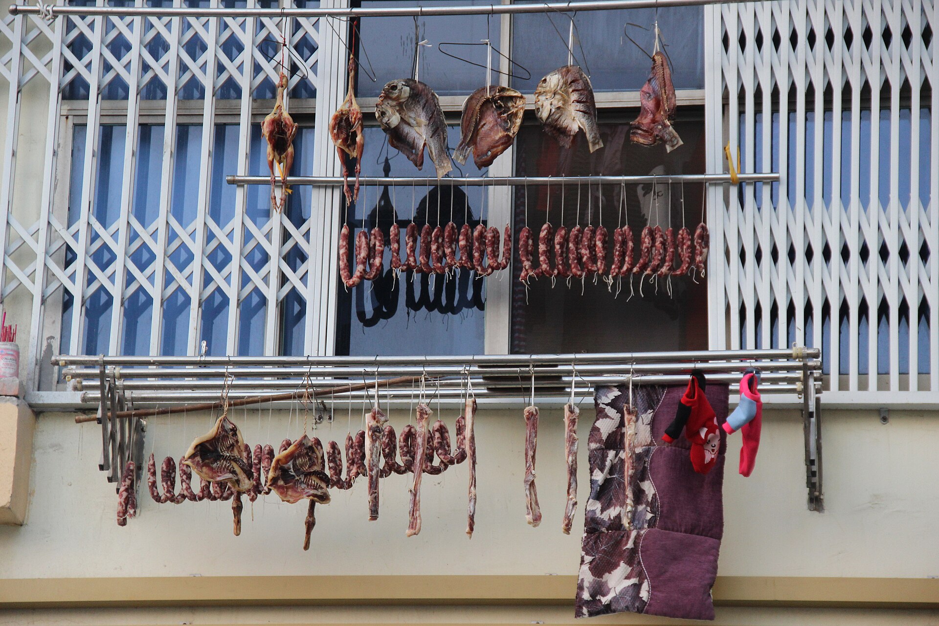 Dated household meat-curing scene at an apartment window in Nanchang