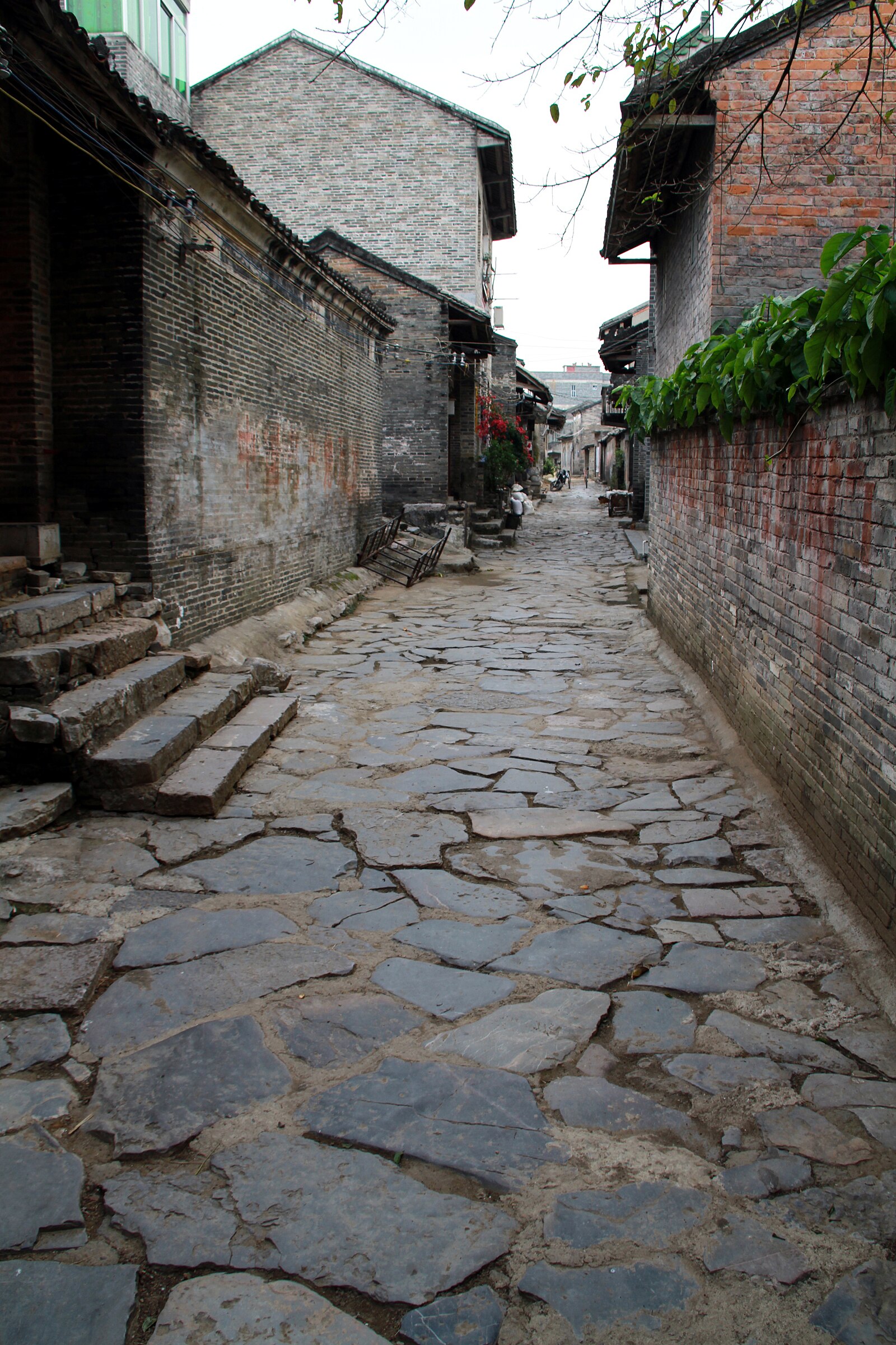 Stone-paved lane between brick buildings in Yangmei