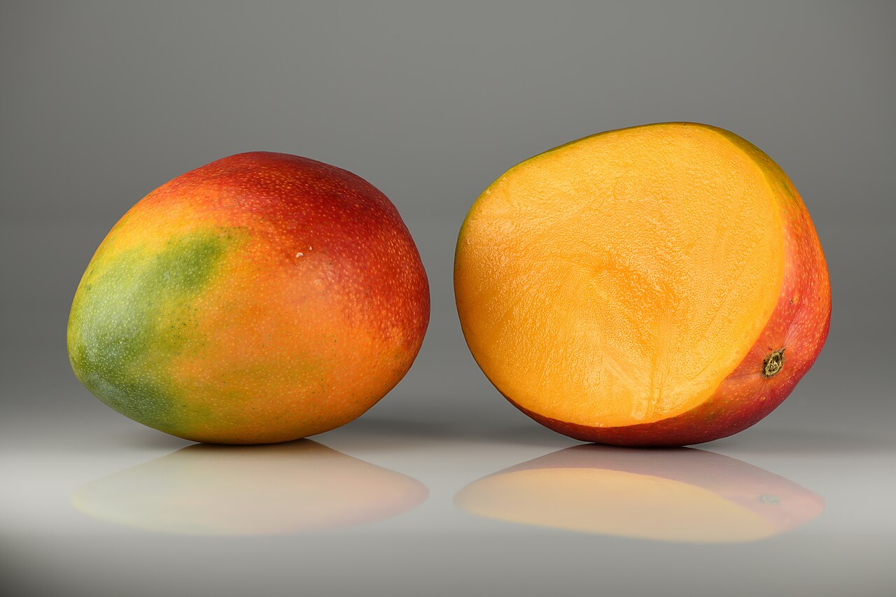 Generic reference photograph of whole and halved mangoes
