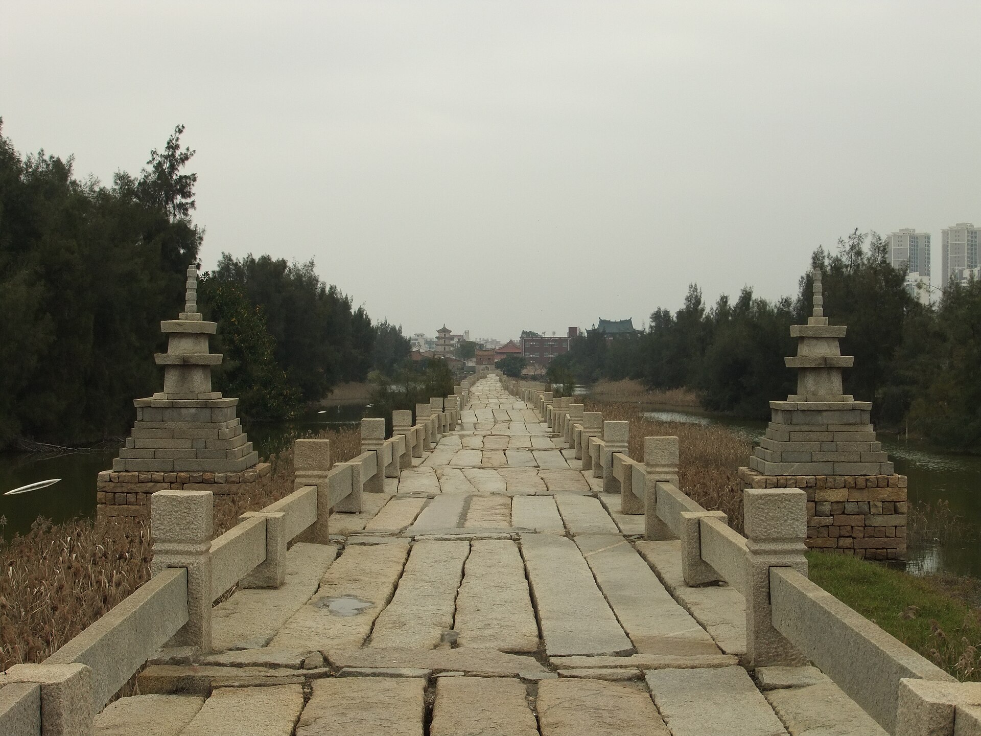 Long straight stone deck, balustrades and small pagodas on Anping Bridge
