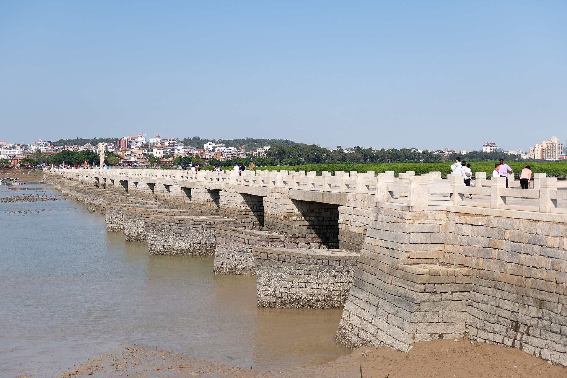 Long stone Luoyang Bridge and piers crossing tidal water and mudflats