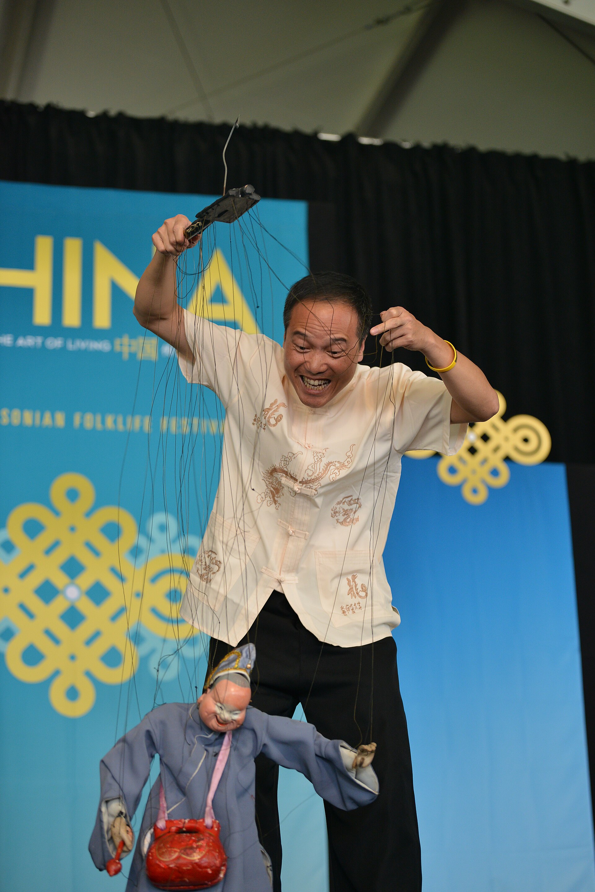 Quanzhou performer operating a string marionette at a 2014 festival
