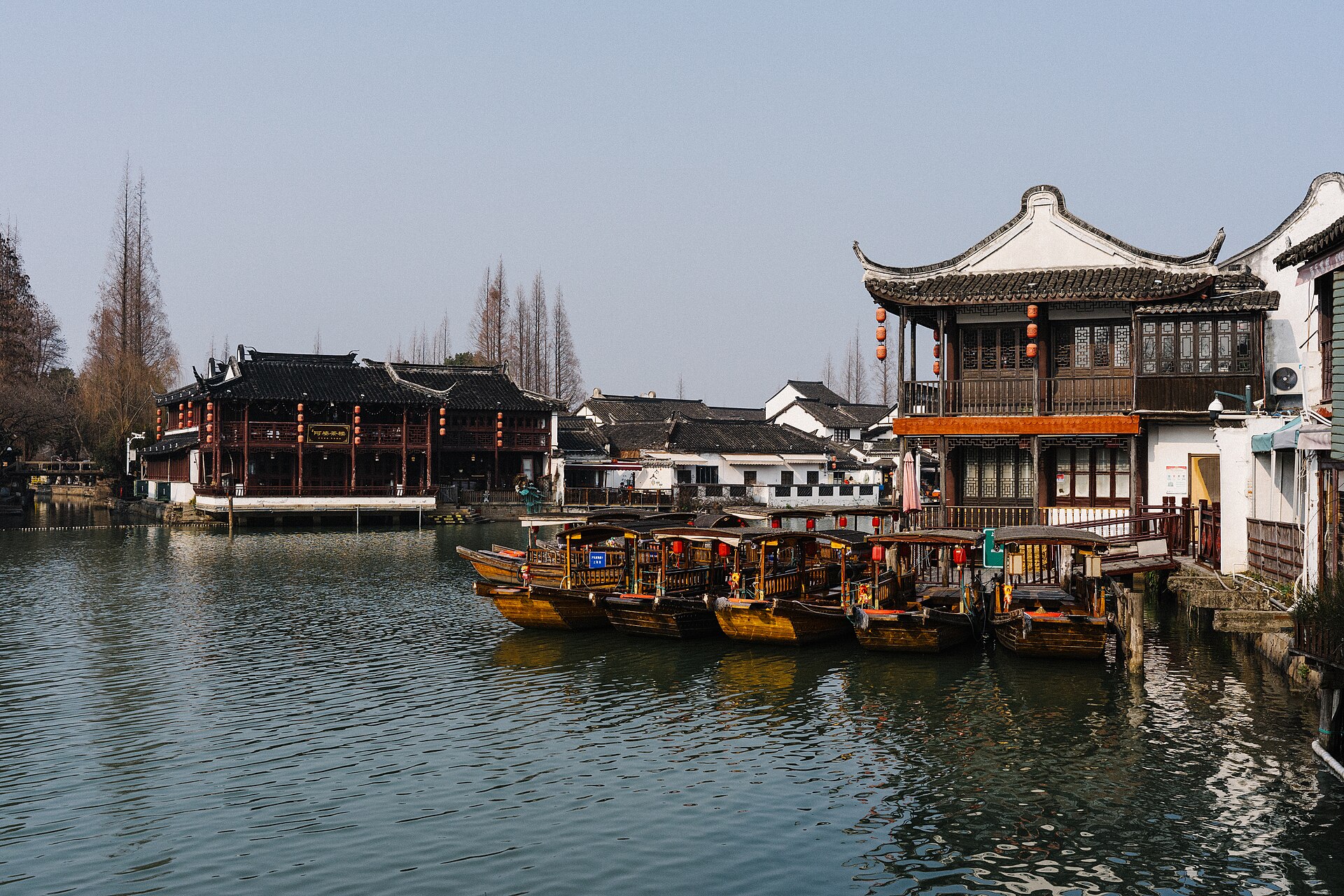Canal in Zhujiajiao lined with white-walled buildings and moored boats