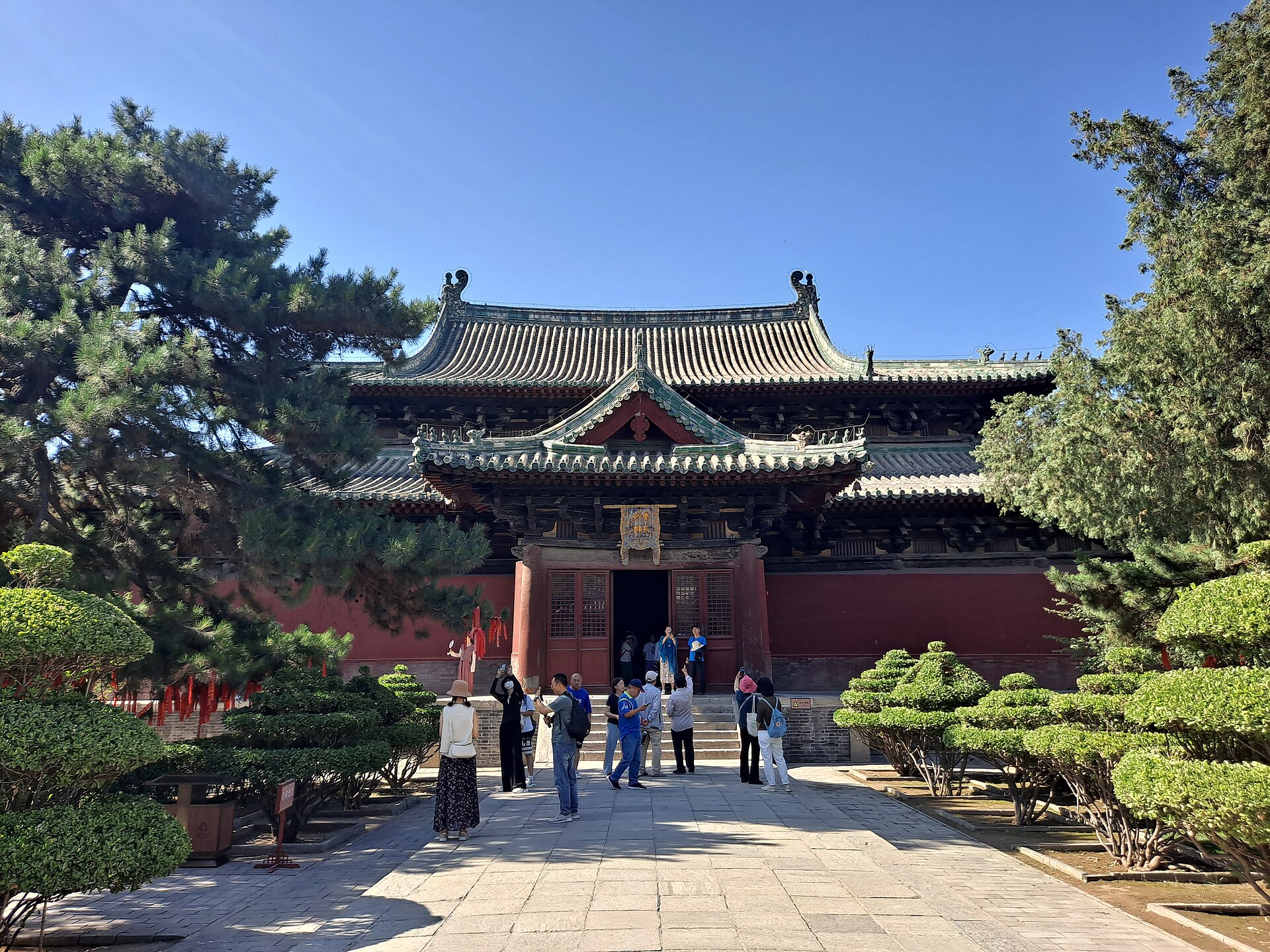 Historic timber hall, roof and visitors at Longxing Temple in Zhengding