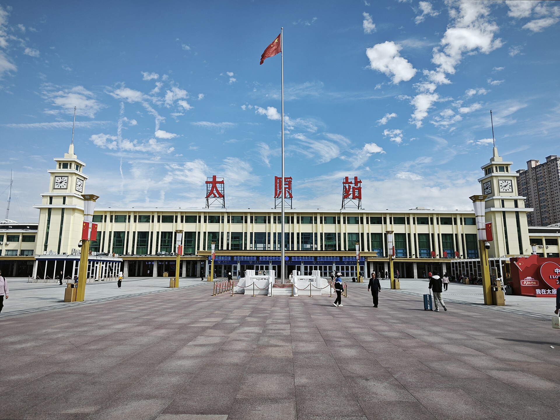 Bright 2025 exterior of Taiyuan Railway Station with forecourt and passengers
