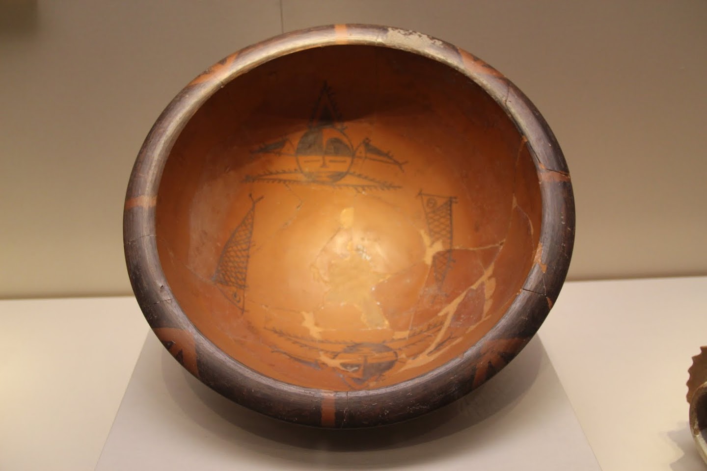 Repaired Banpo painted basin with human-face and fish designs