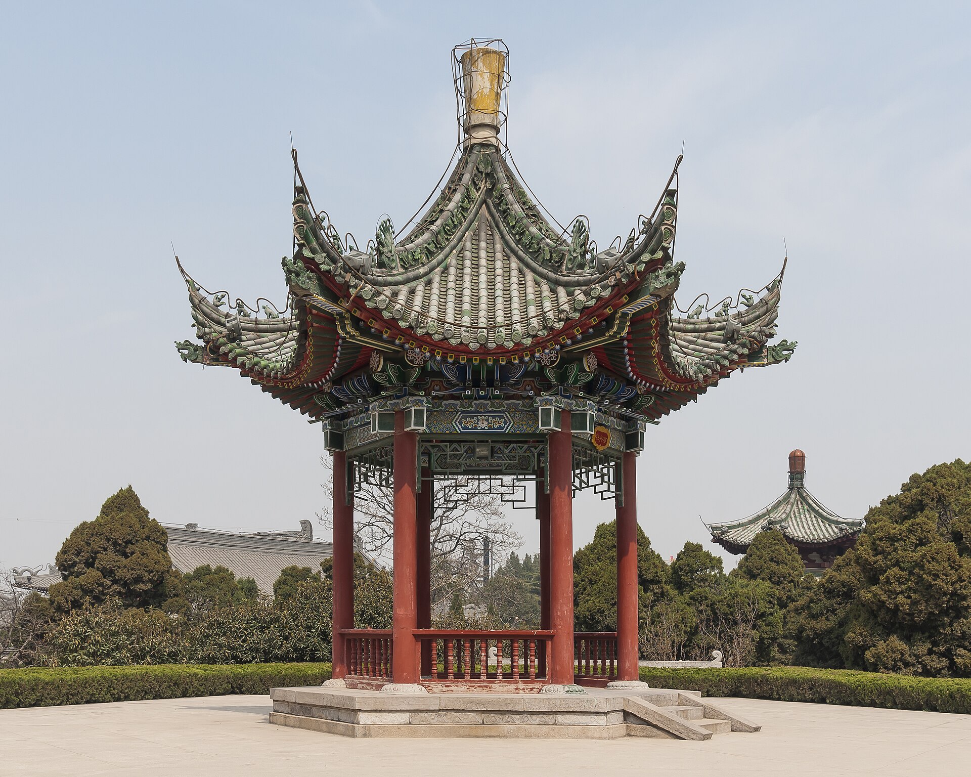 Red-columned pavilion and tiled roofs within Huaqing Palace