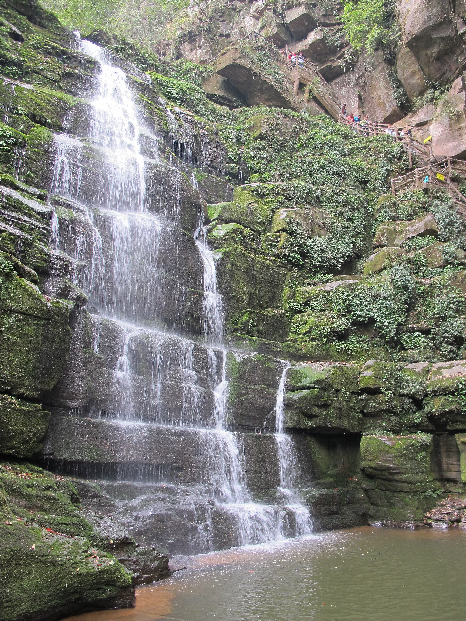 Layered waterfall and steep visitor stairs at Bifengxia