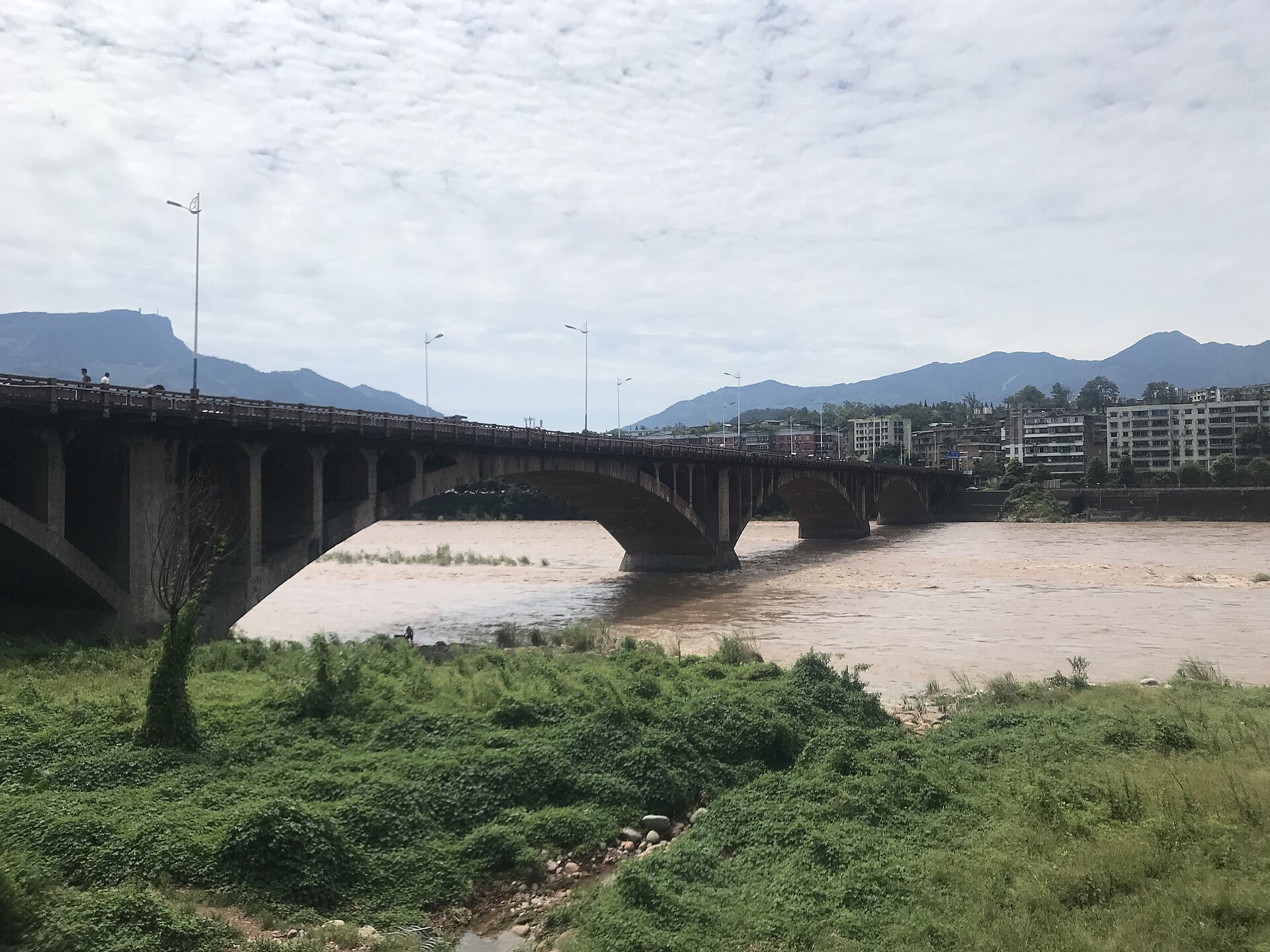 Concrete Westgate Bridge above a high-flow Qingyi River