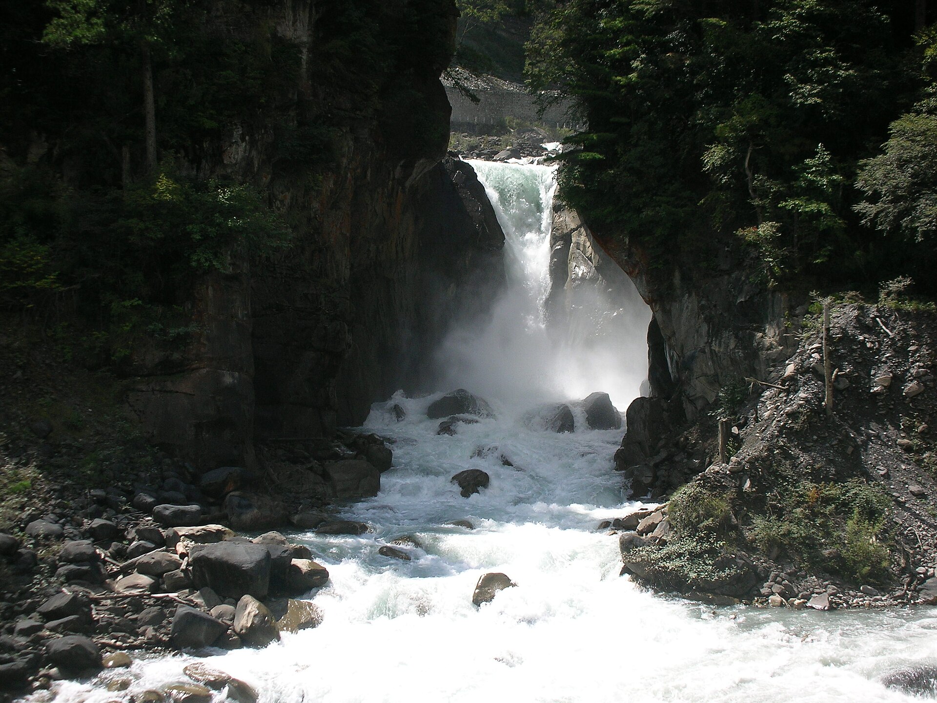 Tall Renzonghai waterfall descending through Shimian mountain terrain