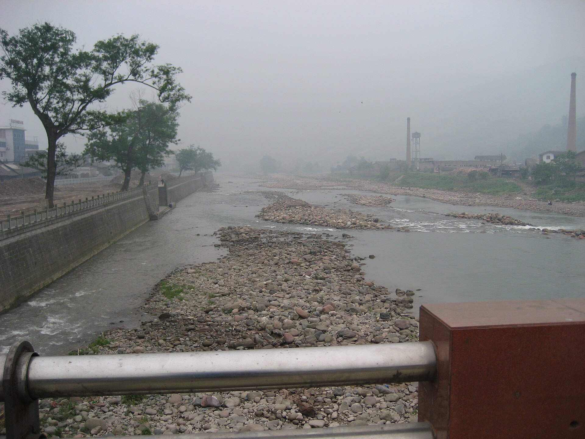 Shallow gravel river and industrial edge in Yingjing