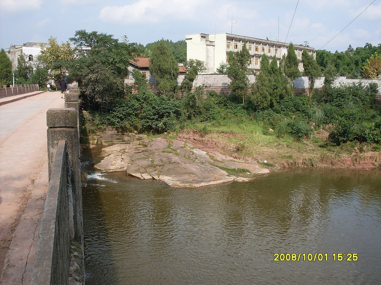 Dated bridge and surrounding county landscape in Lezhi